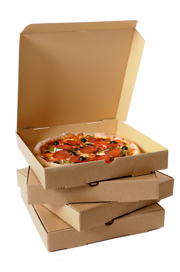 Freshly baked Pizza with a stack of delivery boxes (focus is on the front of the boxes).